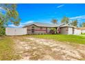 Spacious property featuring a grey single-story home with a fenced yard at 16220 Sw 19Th Avenue Rd, Ocala, FL 34473