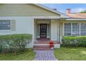 Welcoming front porch with brick accents and decorative wreath on the door, surrounded by lush greenery at 2032 Se 12Th St, Ocala, FL 34471