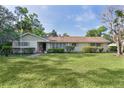 Charming single-story home with a well-maintained lawn and manicured bushes beneath the windows at 2032 Se 12Th St, Ocala, FL 34471