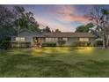 Sunset view of a single-story home with well-kept front lawn and tidy landscaping at 2032 Se 12Th St, Ocala, FL 34471