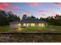 Expansive backyard showcasing a well-maintained lawn, patio, and mature trees for added privacy at 22189 Sw Neptune Blvd, Dunnellon, FL 34431