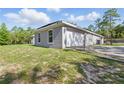 A charming home exterior with a well-kept lawn, a fenced-in yard, and an attached garage at 22189 Sw Neptune Blvd, Dunnellon, FL 34431