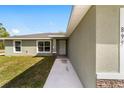 Home exterior showing the entrance, well-kept lawn, and stone accents on the facade at 25 Juniper Pass Way, Ocala, FL 34480