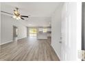 Bright, open-concept living space showcasing sleek floors and a seamless flow into the modern kitchen at 25 Juniper Pass Way, Ocala, FL 34480