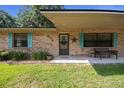 Close-up of home's entrance featuring a cozy bench, decorative star, and colorful shutters at 2576 Ne 34Th St, Ocala, FL 34479