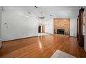Bright living room features beautiful hardwood floors and a classic brick fireplace at 2576 Ne 34Th St, Ocala, FL 34479