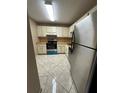 Functional kitchen featuring stainless steel appliances, tile flooring, and light countertops at 2701 Ne 10Th St # 403, Ocala, FL 34470