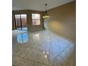Bright living room featuring large windows and sliding glass door that illuminates the tile flooring at 2701 Ne 10Th St # 403, Ocala, FL 34470