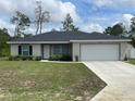 Charming single-story home features a well-manicured lawn and a two-car garage at 3338 Sw 165Th Loop, Ocala, FL 34473