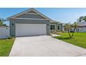 Well-maintained home features a two-car garage and a green lawn at 4064 Sw 132Nd Ln, Ocala, FL 34473