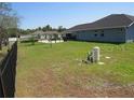 Spacious backyard with a well-maintained lawn, bordered by a sturdy black fence, offering ample privacy at 4770 Sw 114Th St, Ocala, FL 34476