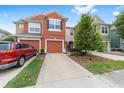 Charming townhome featuring a private driveway, landscaping, and a colorful exterior at 4927 Sw 45Th Cir, Ocala, FL 34474