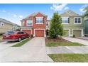 Inviting townhome with a well-kept lawn, private driveway, and colorful facade at 4927 Sw 45Th Cir, Ocala, FL 34474