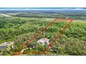 Aerial view shows this home to be secluded among the trees on this large parcel of land at 505 Fisher Rd, Ocklawaha, FL 32179