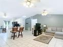 Open concept living area with tile flooring that flows into the dining area and kitchen at 505 Fisher Rd, Ocklawaha, FL 32179