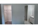 Hallway with view to closet and bathroom, showcasing modern fixtures and ample storage at 5323 Nw 8Th Pl, Ocala, FL 34482