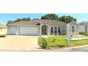 Charming single-story home with a three-car garage, well-kept lawn, and cozy front entrance at 5340 Nw 26Th Ln, Ocala, FL 34482