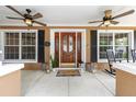 Welcoming front porch with stylish decor, ceiling fans, and ample seating at 5437 Se 34Th St, Ocala, FL 34480