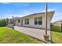 The backyard features a paver patio, built-in grill, and a grassy area with privacy fence at 6557 Se 4Th Ln, Ocala, FL 34472