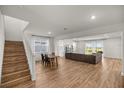 Open-concept living area with wood floors, a large sofa and lots of natural light at 7199 Sw 60Th Ln, Ocala, FL 34474