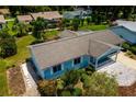 Aerial shot of a blue single-story home with mature landscaping and a brown shingle roof at 8463 Sw 108Th Pl, Ocala, FL 34481