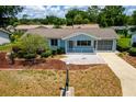 Charming single-story home with a manicured front yard and a cozy screened porch at 8463 Sw 108Th Pl, Ocala, FL 34481