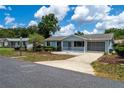 A quaint single-story home with a lovely front porch and a well-manicured lawn at 8463 Sw 108Th Pl, Ocala, FL 34481