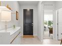 Bright foyer featuring a dark front door and a view of the living area at 9459 Sw 52Nd Loop, Ocala, FL 34481