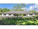 Charming one-story home featuring a brick foundation, neutral paint, shutters, and a well-manicured lawn at 9462 Sw 72Nd Ct, Ocala, FL 34476