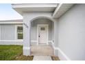 A close-up of the front door with an arched entryway and the house number at 9731 Bahia Rd, Ocala, FL 34472