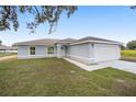 Charming single-story home with a two-car garage and a well-manicured lawn at 9731 Bahia Rd, Ocala, FL 34472