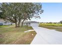 A single-story home with an attached two-car garage and a long driveway at 9731 Bahia Rd, Ocala, FL 34472