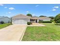 Charming single-story home with a well-maintained lawn, inviting curb appeal, and attached two car garage at 9853 Se 175Th Pl, Summerfield, FL 34491