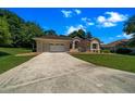 Attractive single-story house with an attached garage and a long concrete driveway at 11586 Sw 75Th Cir, Ocala, FL 34476