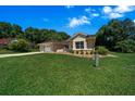 Inviting single-story home with lush green lawn, mature trees, and attached two-car garage at 11586 Sw 75Th Cir, Ocala, FL 34476