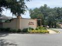 Welcome to The Villages of Silver Lake entrance, with lush landscaping and a charming sign at 1408 Torrey Pines Dr, Lady Lake, FL 32159