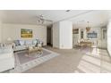 Open-concept living and dining area with neutral color palette, ceiling fan, and lots of natural light at 1408 Torrey Pines Dr, Lady Lake, FL 32159