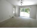 Spacious bedroom featuring a ceiling fan, sliding glass doors, and a large window at 19026 Sw 100Th Pl, Dunnellon, FL 34432