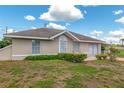 Well-kept single-story home featuring a cozy front patio and manicured landscaping at 21 Pine Trace Run, Ocala, FL 34472