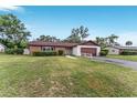 Charming single-story home with brick accents, well-maintained landscaping and two-car garage at 2146 Ne 9Th St, Ocala, FL 34470