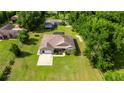 A beautiful aerial view showcasing a well-kept house with a spacious yard and mature trees at 465 Ne 155Th Street Rd, Citra, FL 32113
