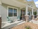 Inviting front porch with decorative chairs and stone pillar accents at 5330 Ne 111Th Lane Rd, Anthony, FL 32617
