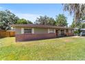 Charming single-story home with brick accents, a green lawn, and white shutters at 6060 Se 119Th Pl, Belleview, FL 34420