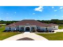 Gorgeous white home with meticulous landscaping and a welcoming circular driveway at 6160 W Highway 326, Ocala, FL 34482