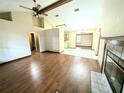 Bright living room featuring hardwood floors, fireplace, high ceilings and open floor plan at 70 Almond Pass Dr, Ocala, FL 34472