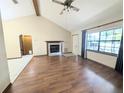 Well-lit living room showcasing hardwood floors, fireplace and large window with natural light at 70 Almond Pass Dr, Ocala, FL 34472