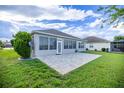 The back exterior features a screened in porch with a paved patio area at 7270 Sw 99Th Cir, Ocala, FL 34481