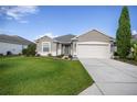 Charming one-story home featuring a well-maintained lawn and a two car garage at 7270 Sw 99Th Cir, Ocala, FL 34481
