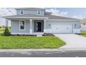 Charming two-story home featuring a well-manicured lawn and a two-car garage with stylish curb appeal at 7536 Sw 60Th St, Ocala, FL 34476