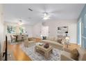 Bright living room showcasing hardwood floors, with coordinated furniture and a dining area at 8463 Sw 108Th Ln, Ocala, FL 34481